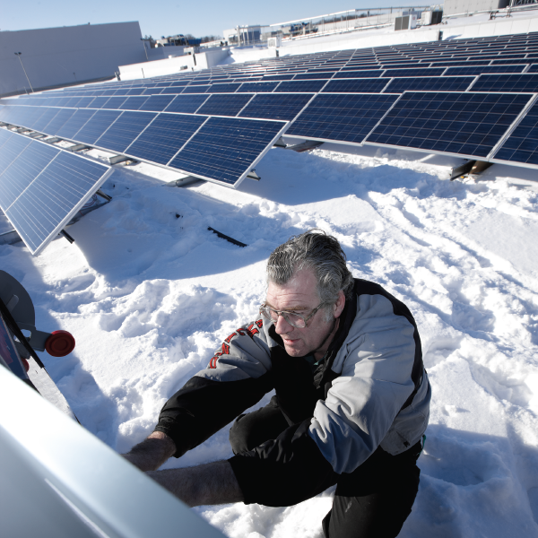 Flanagan employee on Kitchener division roof with solar panels